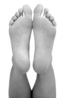 Closeup shot of female feet, isolated on white background photo