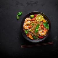 Stir fried noodles with vegetables and shrimps photo