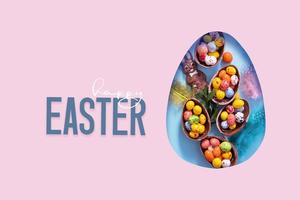 Happy Easter text and cut out Easter egg and chocolate bunny and eggs.  Happy Easter greeting card photo