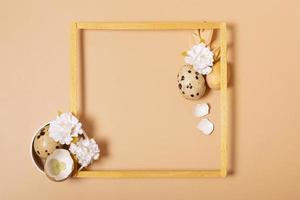 Frame with copy space and Easter eggs composition decorated with twigs and flowers. Easter flat lay monochrome photo