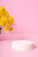 Podium or pedestal with chrysanthemum flowers. Mockup for your cosmetic products photo