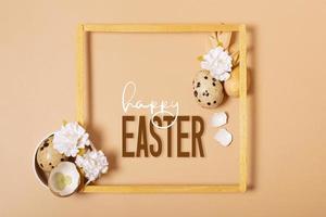 Frame with Happy Easter text and eggs composition decorated with twigs and flowers. Easter greeting card photo