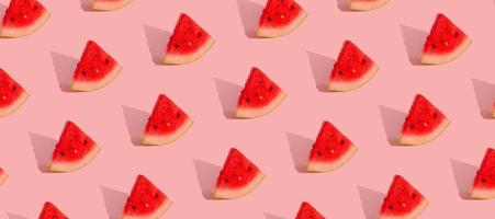 Pattern with watermelon slices isolated on pink.Abstract summer background. Banner format photo