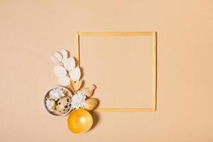 Frame with copy space and Easter eggs composition decorated with twigs and flowers. Easter flat lay monochrome photo