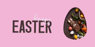 Happy Easter text and cut out Easter egg and chocolate bunny and eggs.  Happy Easter greeting card photo