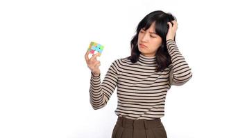 Asian woman holding a puzzle cube standing on white background. solving cubic problems, problem solution and making strategic moves concept photo