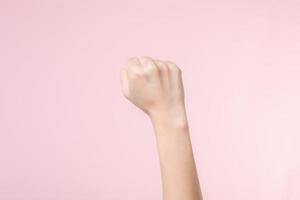 Woman fist fight for human rights and feminist with pink pastel background. Women empowerment, equality, strength and courage concept photo