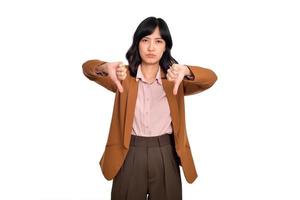 Dislike. Disgusted asian woman showing thumbs down and grimacing, commenting on smth bad, disagree, complaining, standing over white background photo