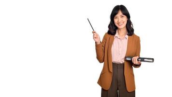 Happy young asian business woman holding notepad and pointing pencil up isolated on white background photo