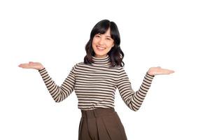 Young asian woman, professional entrepreneur standing in casual clothing, smiling and looking at camera, white background photo