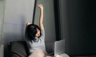 Asian woman has shoulder pain while working on laptop at home. People with body-muscles problem, Healthcare And Medicine. photo
