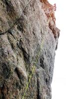 Woman mountaineer, young people mountaineer climbing a difficult route on a rock. Climber climbs a rocky wall. With safety rope on the rock photo