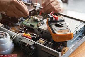 multimeter and background with technician measures voltage , electrical work concept ,selective focus photo