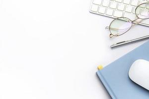 teclado, computadora ratón y cuaderno con bolígrafo en blanco oficina escritorio foto