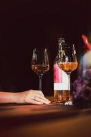 Woman hand holding wine glass on dinner table in the restaurant. photo