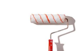 Striped paint roller with a red handle on a white background. photo