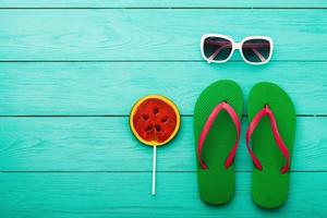 Flip flops. Beach holidays. Summer accessories and copy space on blue wooden background. Top view. Mock up. Copy space photo