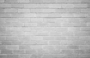 Full frame shot of white concrete wall textured and background. A concrete wall is a wall constructed of concrete blocks of uniform size. photo