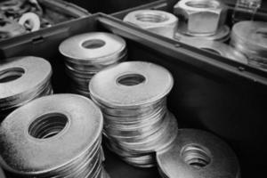 Metal steel washers, nuts, shop window. Black and white photo. Close-up. photo