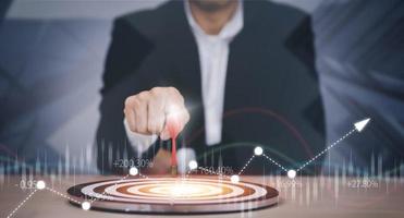 Targeting the business concept, Businessman hand holding red dart to the virtual target dartboard, Executive marketing, investment goal and target for business investment concept, photo