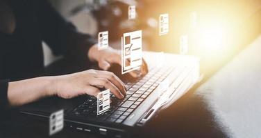 Hand using laptop and touch folder of document Management System, online documentation database and process automation to efficiently manage files work, knowledge, Corporate business technology, photo