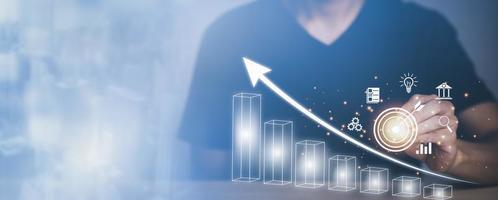 Man using pan touch target and analytics and financial concept, Plans to increase business growth and an increase ,Technology and Business trend analysis concepts, with business graphs, Tax concept. photo