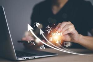 Startup concept Laptop with icon business and network connection on modern virtual interface from digital tablet.Businessman Touching tablet and graph Screen Icon of media screen, Technology Process photo