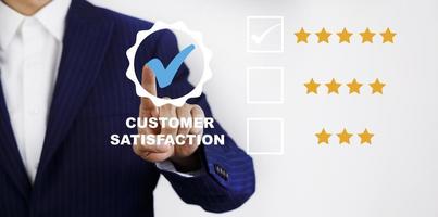 Businessman touch with Customer review satisfaction feedback survey concept, User give rating to service experience on online application, service leading to reputation ranking of business. photo