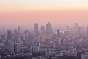Bad air pollution in City. PM 2.5 dust in Bangkok or center city, Capital city are covered by heavy smog, Misty morning and sunrise in downtown with bad air pollution, Place to risk of cancer,Thailand photo