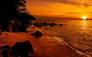 Beach golden hour sunset with rocks photo