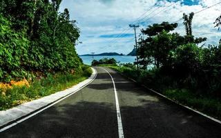 Landscape with hill and empty road toward the beach photo