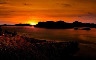 Golden hour sunset with sea and island photo