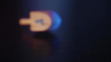 Dreidel spinning on a wooden table video