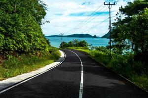 Landscape with hill and empty road toward the beach photo