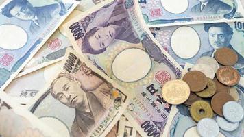 Japanese yen notes and Japanese yen coins for money concept background photo