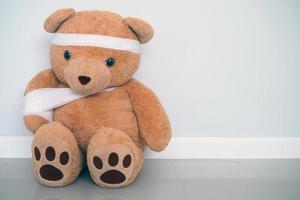 Teddy bears have gauze, wound on the arms and head. Child injury concept photo