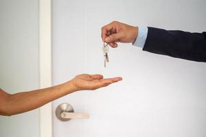 Home buyers are taking home keys from sellers. Sell your house, rent house and buy ideas. photo