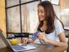 Asian girls are happy to order products via computer and pay online by credit card.