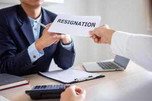 Employee businessman submit or sending resignation document letter to human resource manager or boss, Change of job, unemployment, resign concept. photo