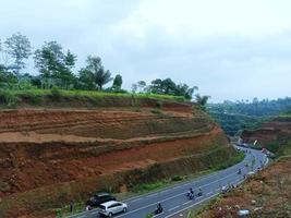 Cliff near the highway with red soil conditions. photo