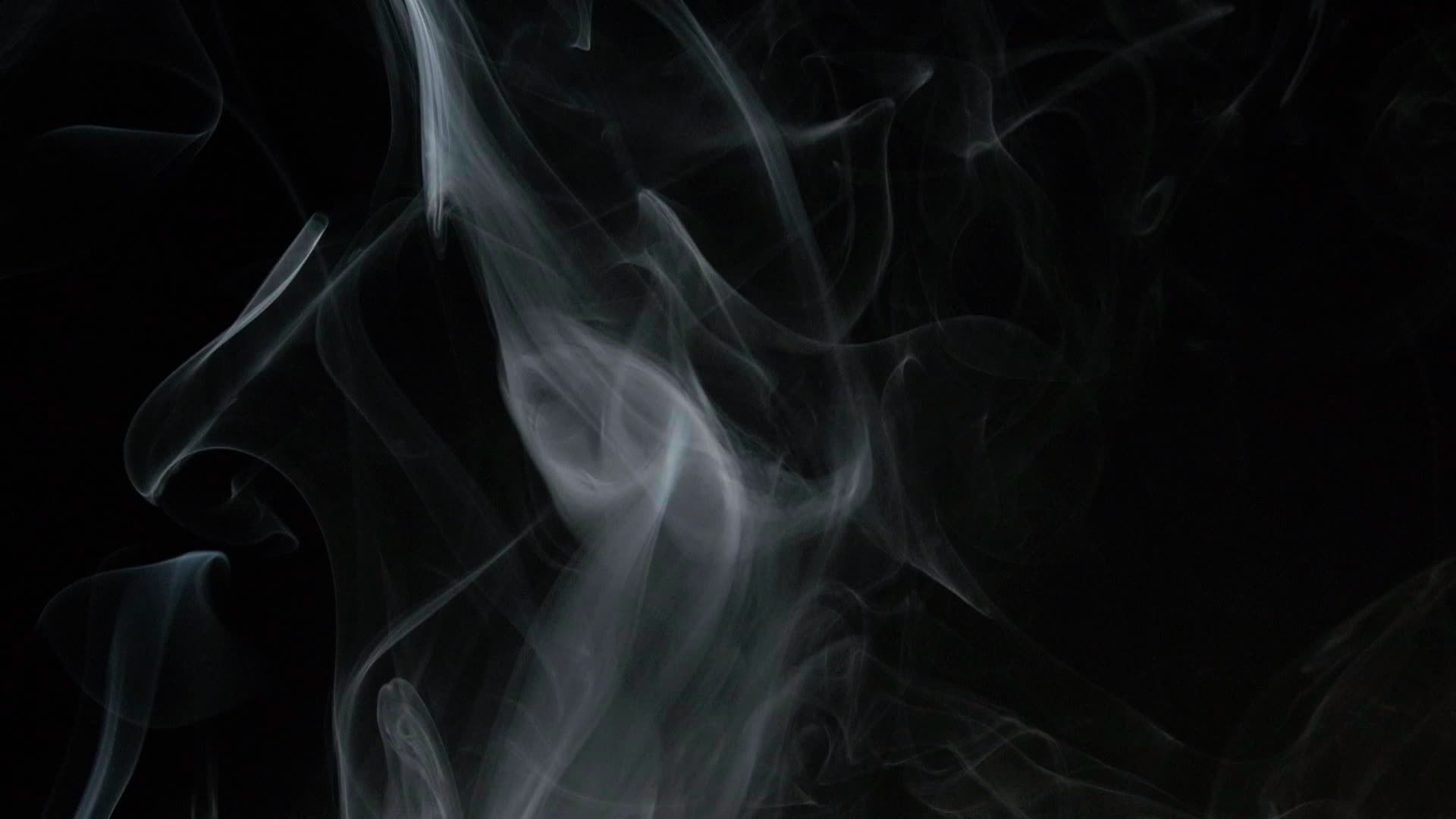 Slow motion of white smoke, fog, mist, vapor on a black background