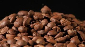 Slow motion of roasted coffee beans falling. Organic coffee seeds. video