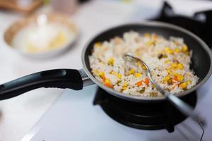 Rice with vegetables in a pan with spoon. photo