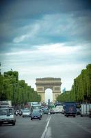 the champs elysees with its long street that ends with the triumphal arch, symbol of paris capital of france. in the summer of 2012 photo