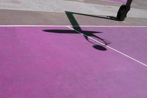 shadows on the purple street basket court, purple background photo