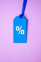 percent symbol on the blue price tag, pink background photo
