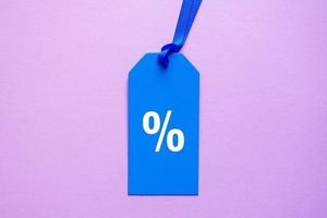 percent symbol on the blue price tag, pink background photo