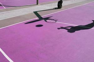 shadows on the purple street basket court, purple background photo