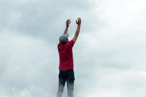 hombre retrato gesticulando en el cielo y nubes foto