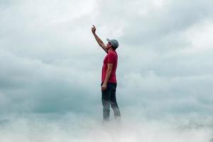 man portrait gesturing in the sky and clouds photo